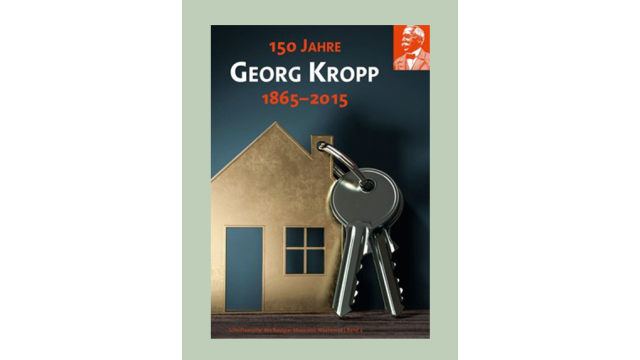 Auf dem Buchcover ist ein Hausmodell mit einem silbernen Schlüsselbund daran dargestellt, dazu der AUfdruck 150 Jahre Georg Kropp 1865 - 2015